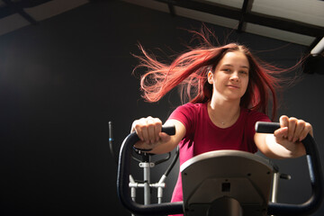 Young woman training fitness workout on bicycle