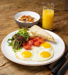 fried eggs with tomatoes and oatmeal 

