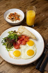 fried eggs with tomatoes and oatmeal 
