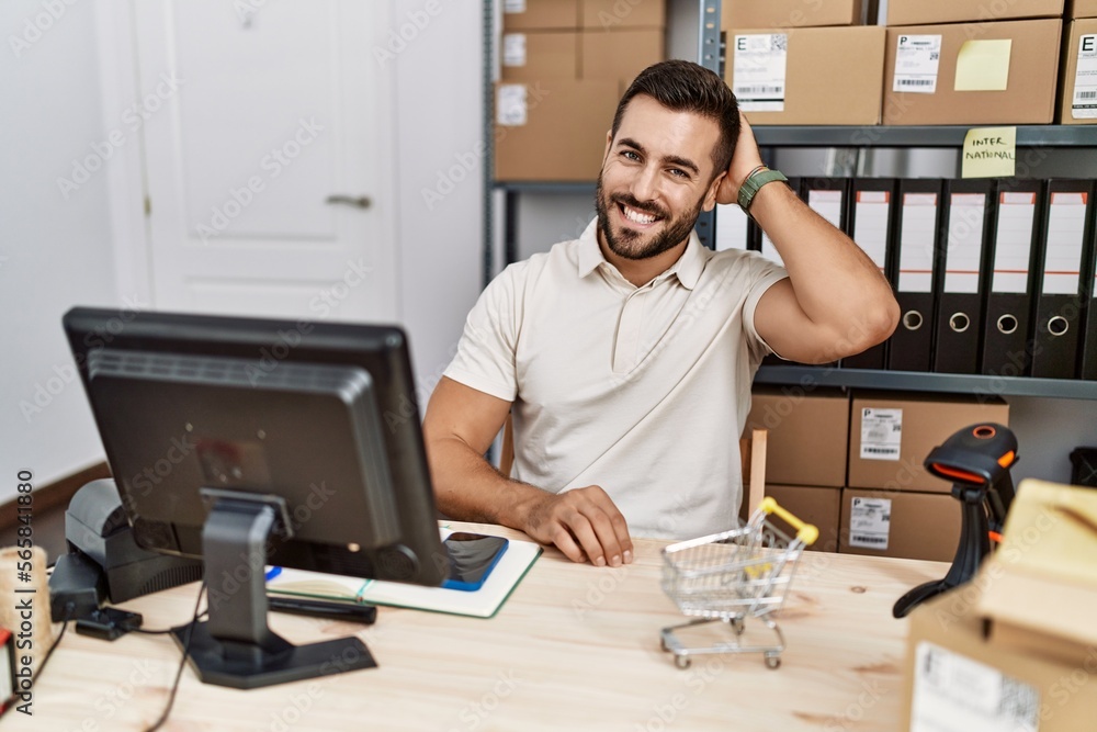 Sticker Handsome hispanic man working at small business commerce smiling confident touching hair with hand up gesture, posing attractive and fashionable