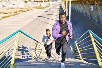 Man and woman couple wearing sportswear running at street