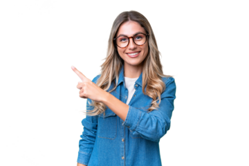 Young Uruguayan woman over isolated background pointing to the side to present a product