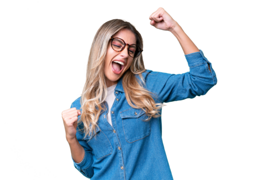 Young Uruguayan woman over isolated background celebrating a victory