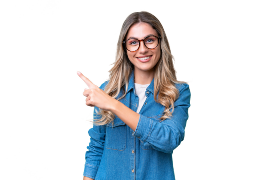 Young Uruguayan woman over isolated background pointing to the side to present a product