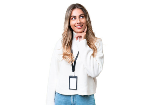 Young Uruguayan woman with ID card over isolated background thinking an idea while looking up
