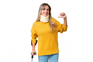 Young Uruguayan woman wearing neck brace and crutches over isolated background proud and self-satisfied