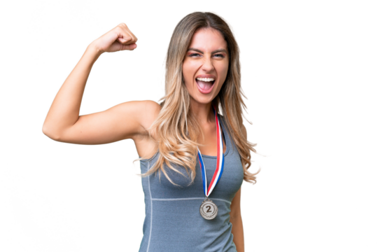 Young pretty sport Uruguayan woman with medals over isolated background doing strong gesture