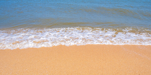Fototapeta na wymiar The coast of the Sea of Azov. Sea waves roll on the sandy shore. Seashell sandy beach.