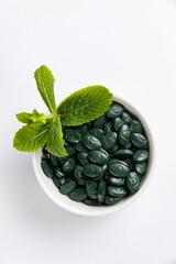 Spirulina is a useful supplement. on a white background
