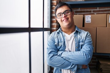 Down syndrome man ecommerce business worker standing with arms crossed gesture at office