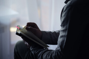 Read book. A man sits and reads literature. Textbooks to study. Religion.