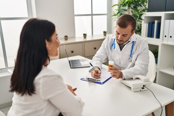 Fototapeta premium Man and woman doctor and patient having medical consultation prescribe pills at clinic