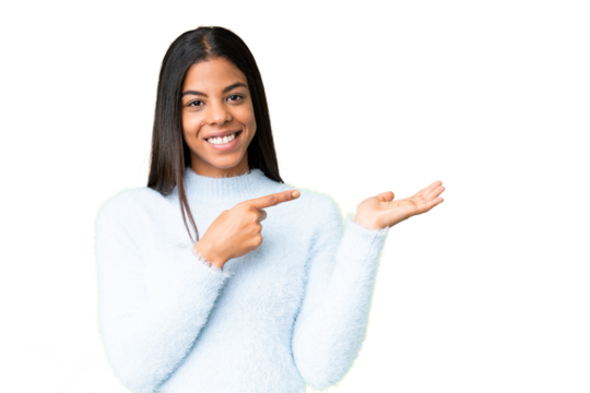 Young African American woman over isolated chroma key background holding copyspace imaginary on the palm to insert an ad