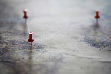 Travel concept. Map and needle with a marked place. Compass point on the map and routes.