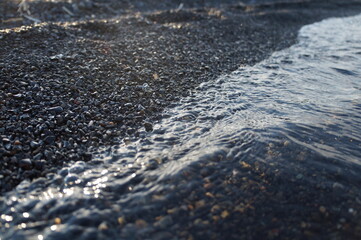 Fragment of a wave on the black coast