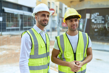 Two hispanic men architects smiling confident standing at street