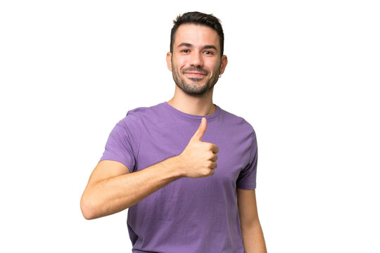 Young handsome caucasian man over isolated background giving a thumbs up gesture