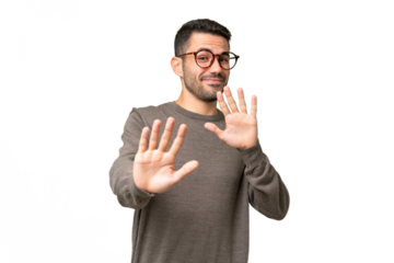 Young handsome caucasian man over isolated background nervous stretching hands to the front