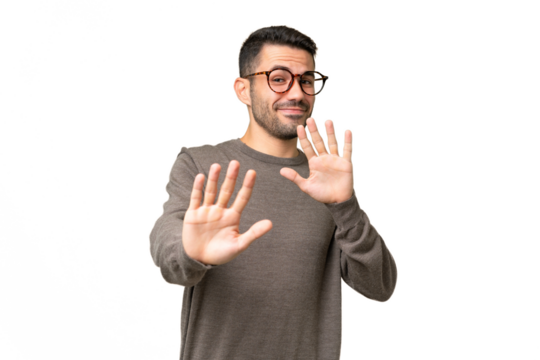 Young handsome caucasian man over isolated background nervous stretching hands to the front