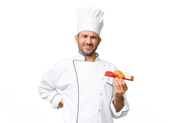 Young caucasian chef holding a sushi over isolated background suffering from backache for having made an effort