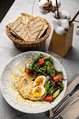 delicious hummus with greens and tomatoes
