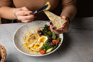 delicious hummus with greens and tomatoes
