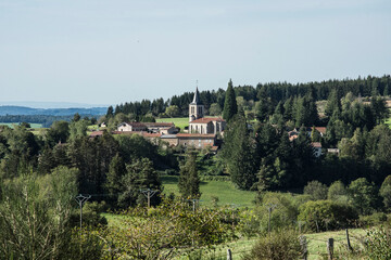 small village with church in a valley in the volcano mountains of the Auvergne