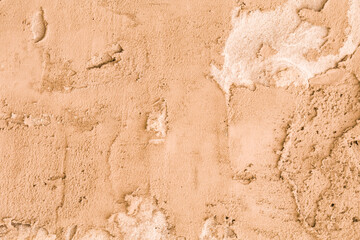 Abstract background of brown plaster, spoiled by time.