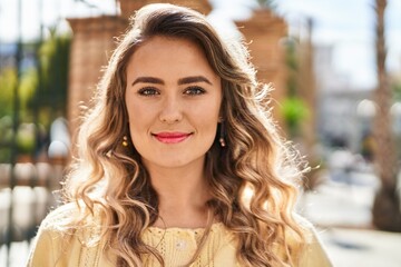 Young woman smiling confident standing at street