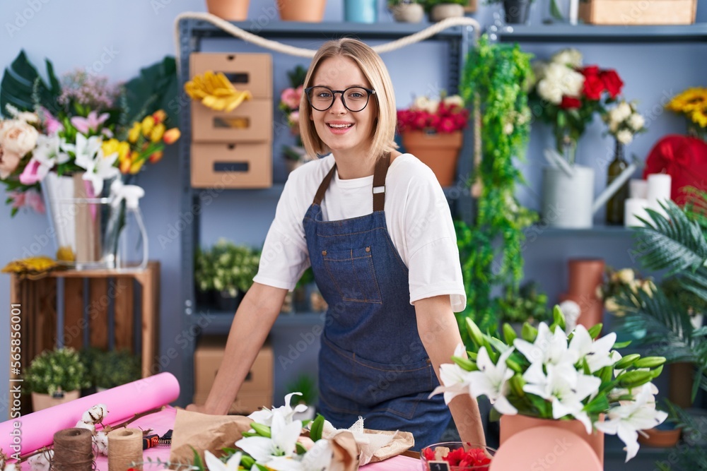 Poster young blonde woman florist smiling confident standing at florist shop