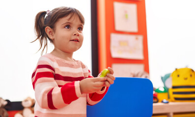 Adorable hispanic girl smiling confident standing at kindergarten