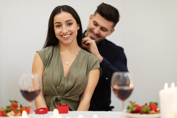 Happy young couple in love drinking wine, celebrating Valentines day
