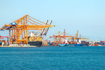 Fototapeta premium Large cargo container ship loaded with containers in the seaport