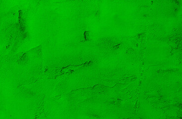 Green paint painted on rough wall background .