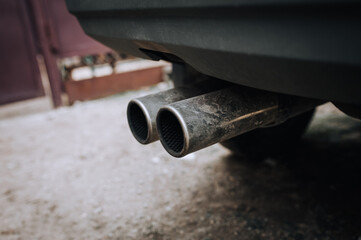 Fototapeta na wymiar Two exhaust pipes of a sports car close-up.