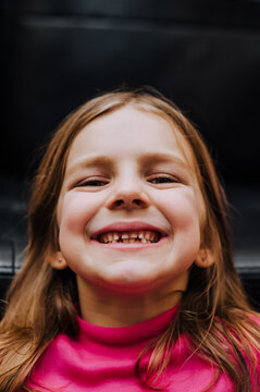 Photography, closeup portrait of a beautiful little laughing girl, child. Emotion concept.