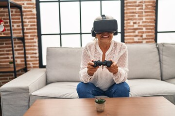 Middle age woman playing video game at home