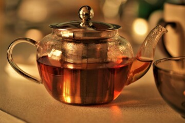 Black tea brewed in a teapot on the table 