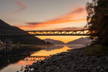 Bridge over river at sunset