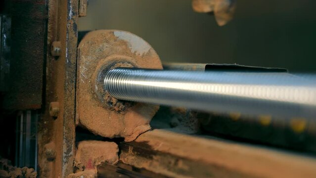 A ball screw that rotates between the screw axis and the nut on a CNC machine close-up