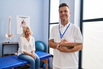 Middle age man and woman physiotherapist and patient having rehab session at physiotherapy clinic