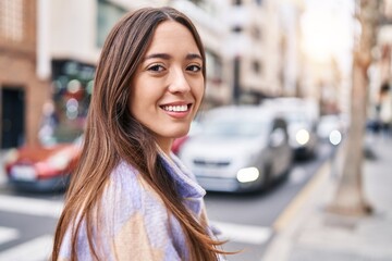 Young beautiful hispanic woman smiling confident standing at street