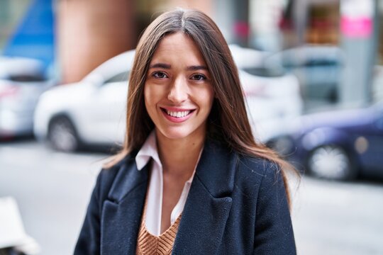 Young beautiful hispanic woman smiling confident standing at street