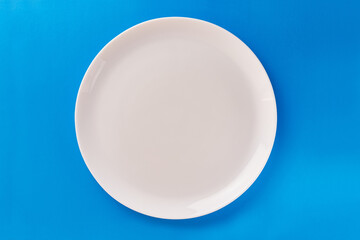 White plate on a blue background. Graphic background for designers.