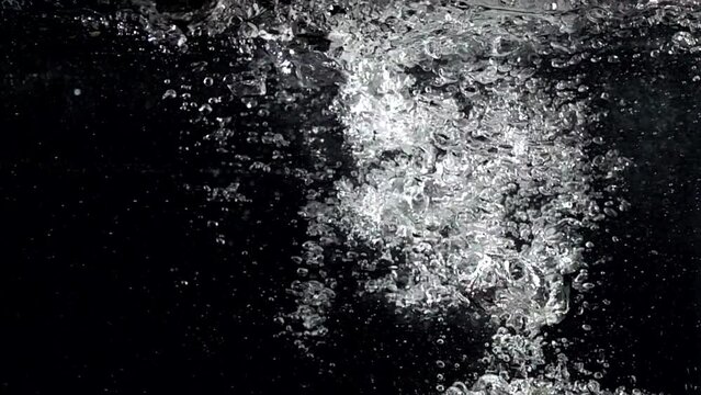Super slow-motion shot of water splash against black. Shooted with high speed cinema camera at 1000fps
