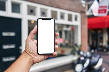 Man holding smartphone showing white blank screen at amsterdam