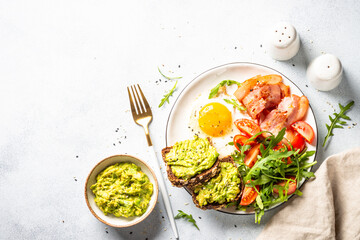 Healthy breakfast or lunch. Becon, eggs and fresh salad.