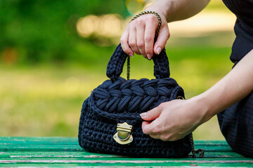 Wicker or knitted women's handbag close up with selective focus on blurred background