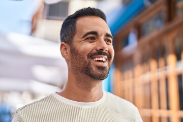 Young hispanic man smiling confident standing at street