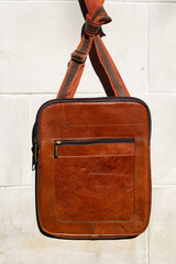close-up photo of light brown messanger leather bag